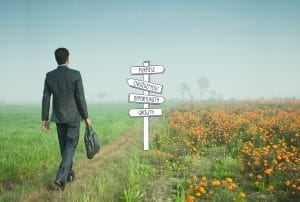 a man walking in a field with a sign that says purpose engagement opportunities and growth