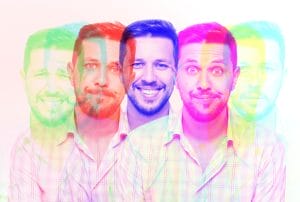 a man with a beard is surrounded by a rainbow of colors