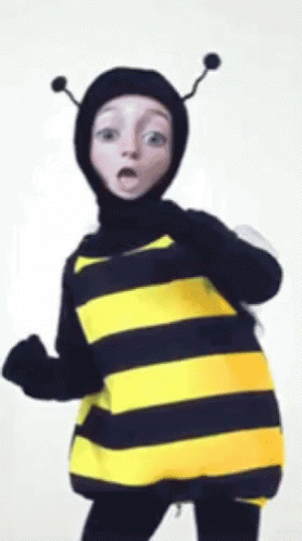 a child is dressed in a bee costume