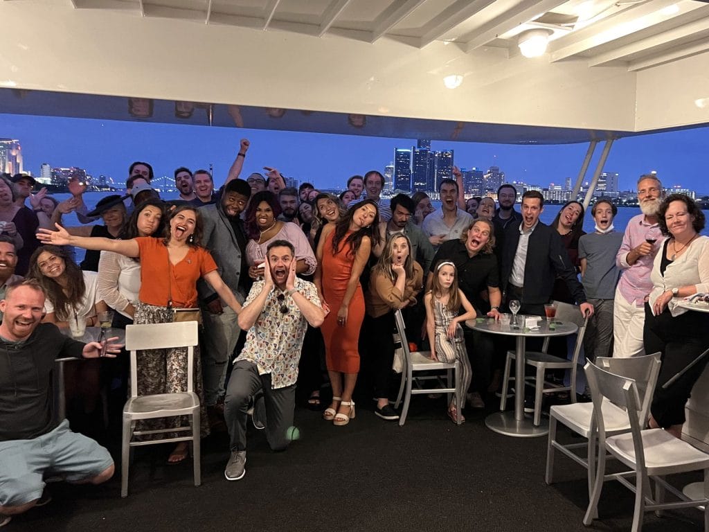 Nutshell and WebFX members are posing for a picture at a boat party