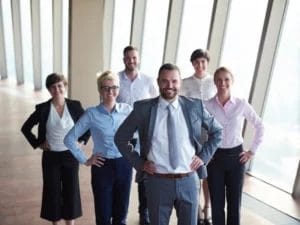 a group of business people posing for a picture with their hands on their hips