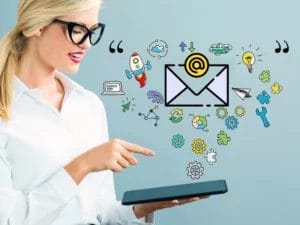 a woman is holding a tablet with a drawing of an envelope coming out of it