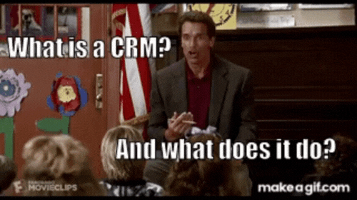 a man in a suit is talking to a group of children and asks "what is a CRM, and what does it do?"