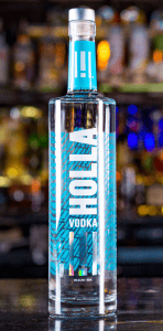a bottle of holla vodka sits on a bar