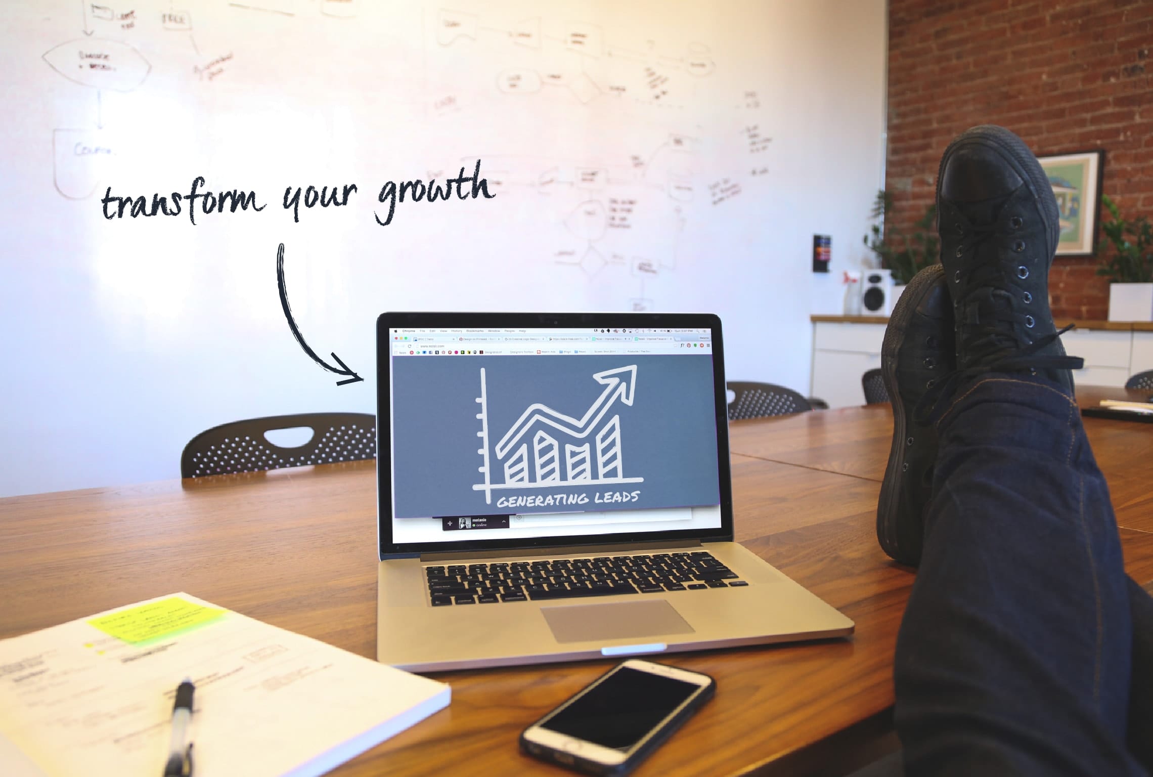 en persons fødder hviler på et bord med en bærbar computer med ordene transform your growth