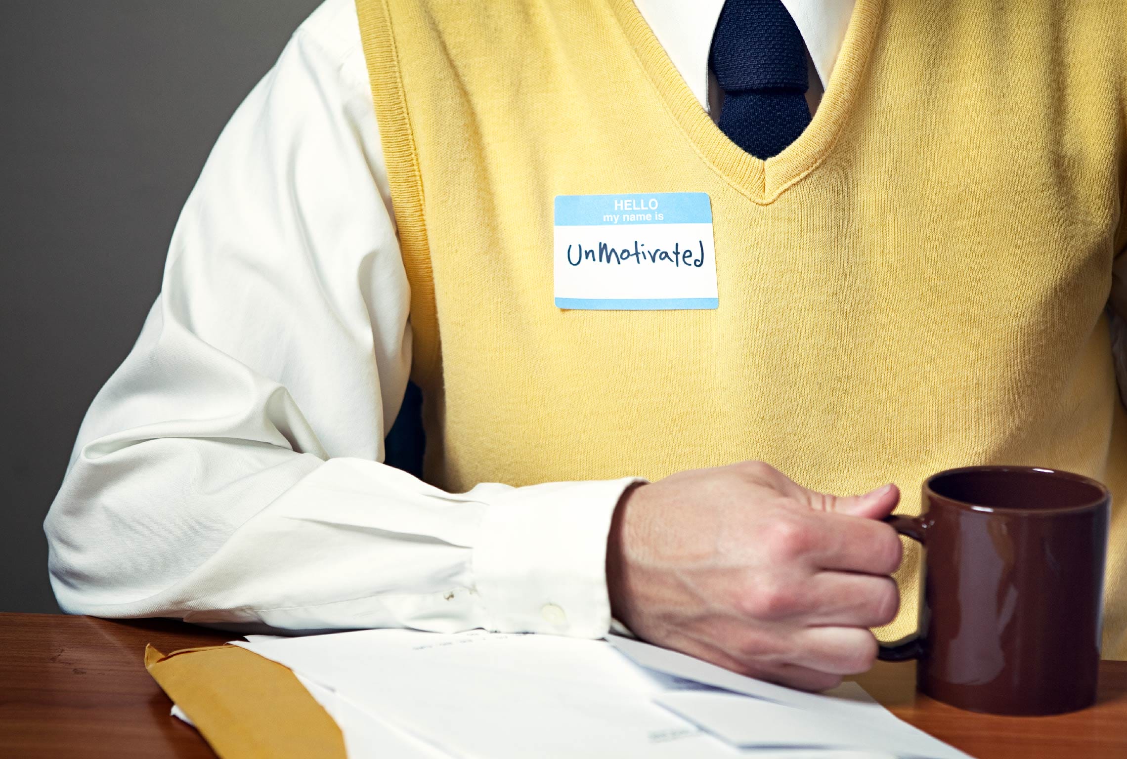 a man wearing a name tag that says unmotivated