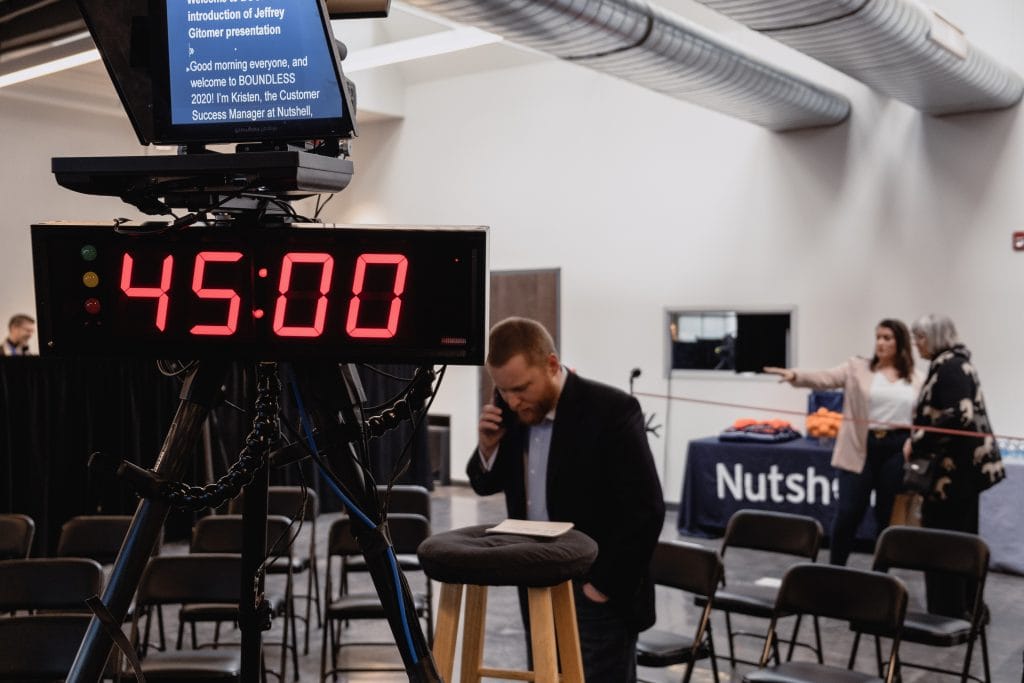 a man on the phone in front of a timer that reads 45.00
