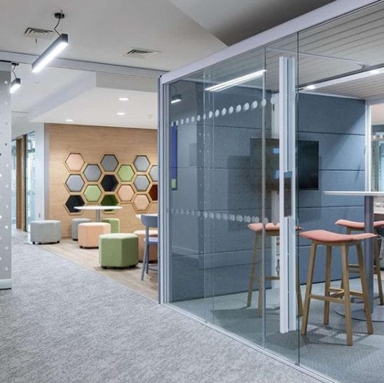 a room with tables and stools and a glass wall