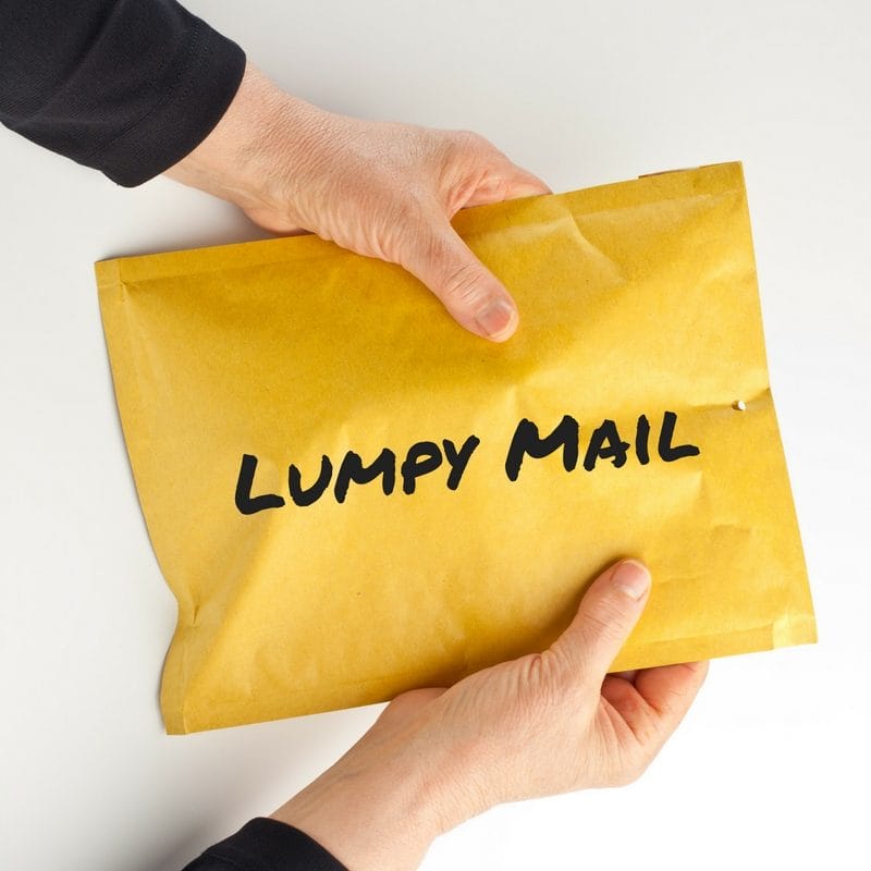 a person is holding a yellow envelope that says lumpy mail
