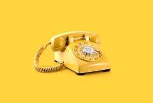 a yellow telephone with a dial that says' dial-up' on it