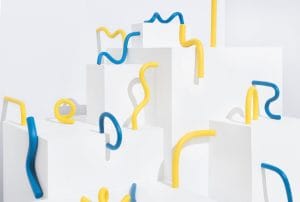 a bunch of blue and yellow pipes are sitting on white blocks