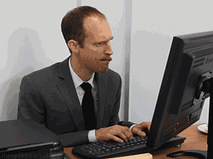 a man in a suit and tie is typing on a computer keyboard