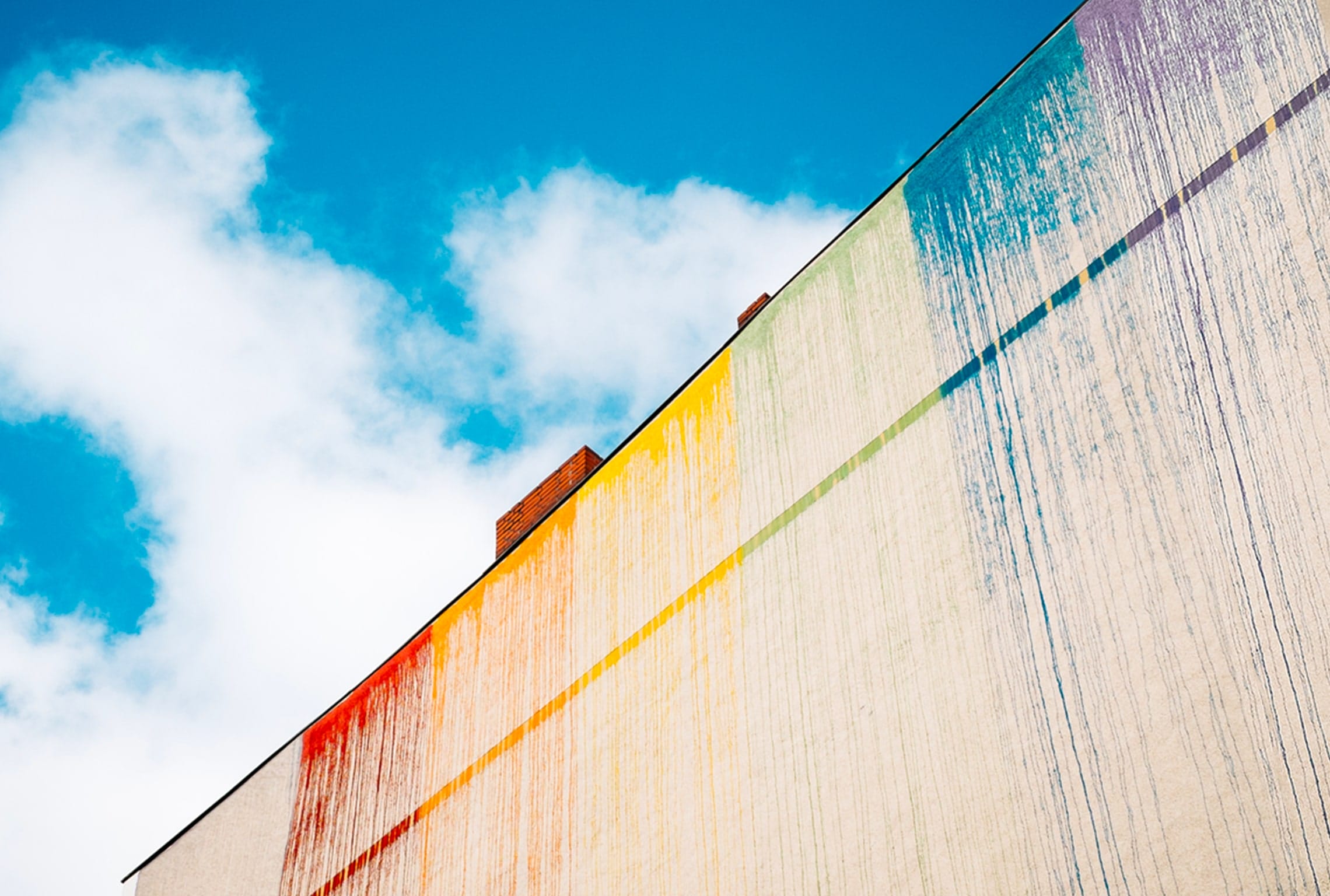 a building with a rainbow of colors painted on it