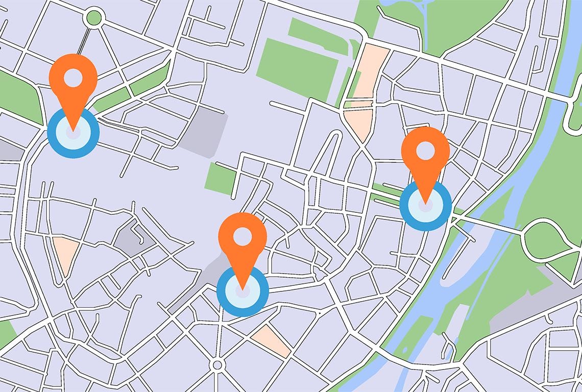 a map of a city with three orange pins on it