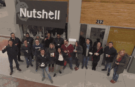 Nutshell staff standing in front of Nutshell office and waving