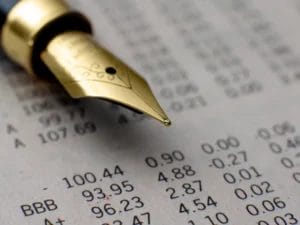 a fountain pen is sitting on top of a piece of paper with numbers on it