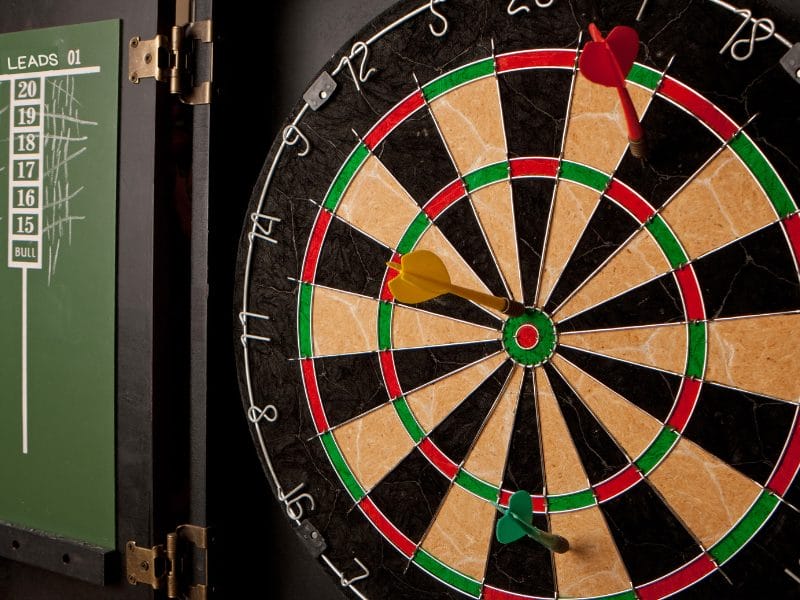 a dart board with two darts in it