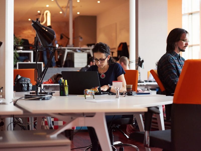 person working on their laptop at a desk
