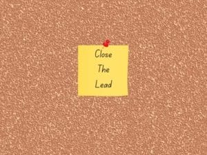 a sticky note that says Close the lead is pinned to a cork board
