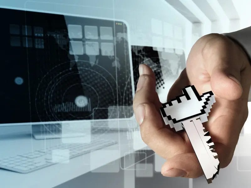 a hand holding a pixelated key with a cursor hand on it