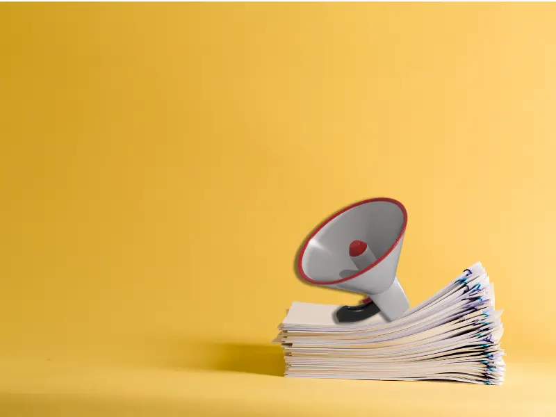 a megaphone is sitting on top of a stack of papers