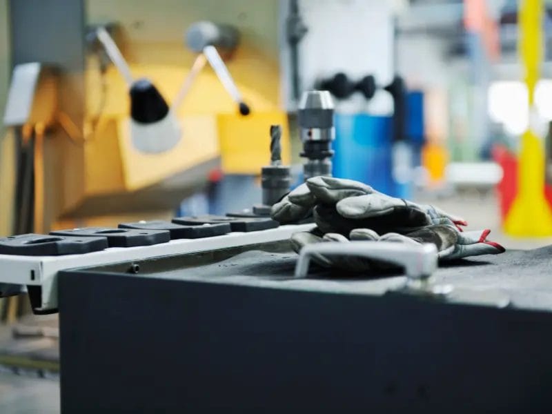 a pair of gloves sitting on a table in a workstation