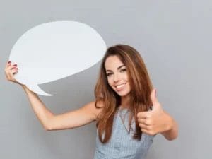 a woman is holding a speech bubble and giving a thumbs up