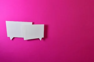 two speech bubbles on a pink background
