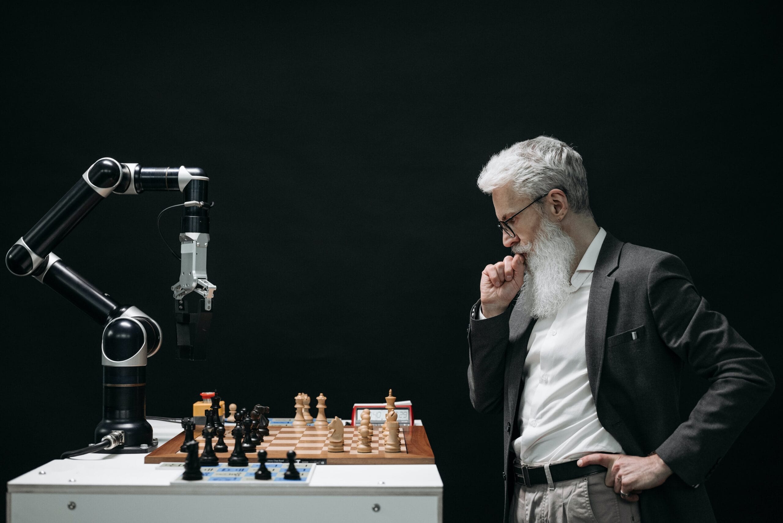 man playing chess with a robot