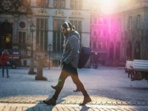 Man walking and listening to a podcast with headphones