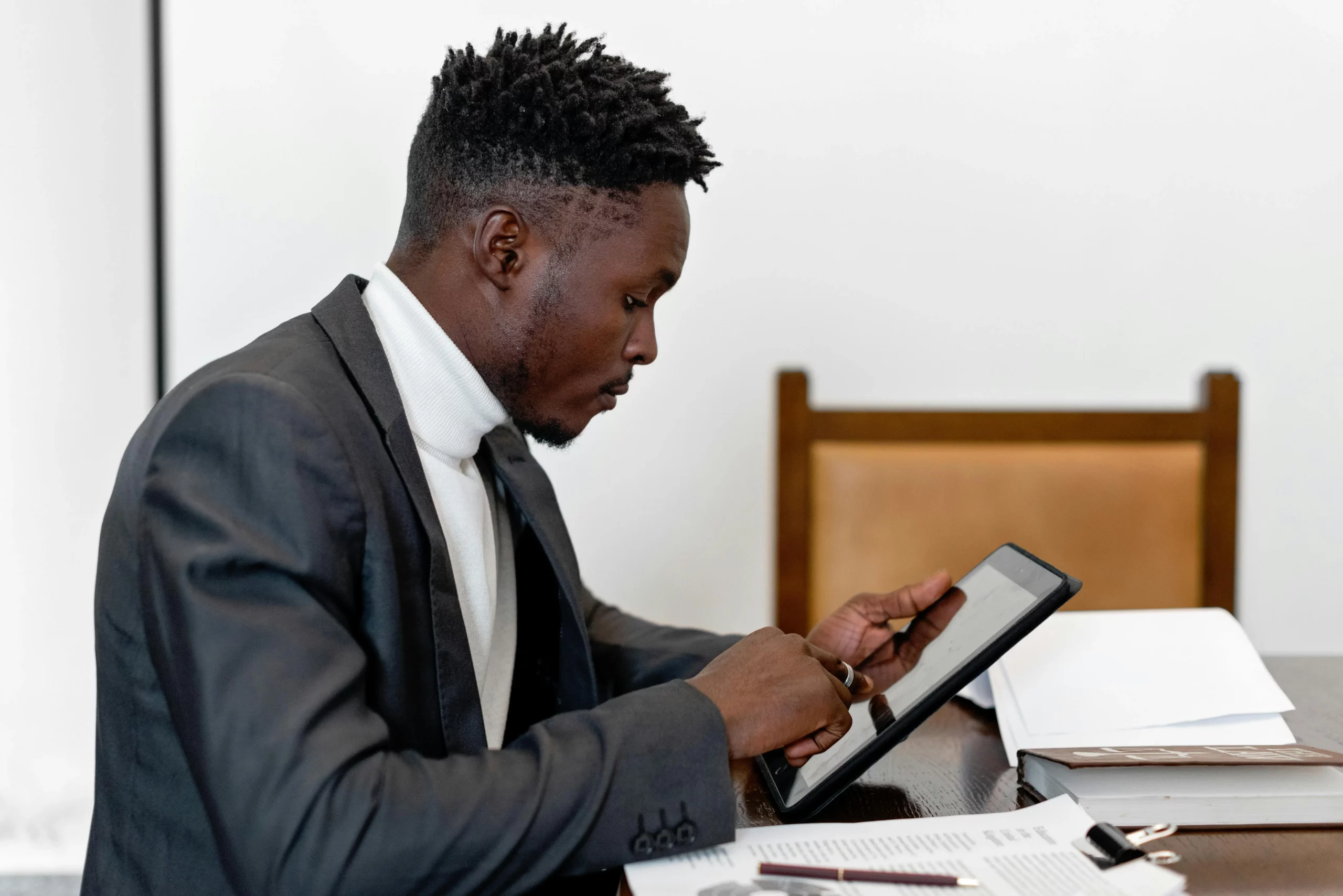 Man signing a document on a tablet