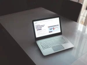 a laptop is open on a table with a page about Landing Pages on the screen