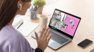a lady on a video call waving to the camera