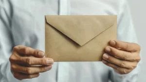 a person holding a brown envelope with both hands